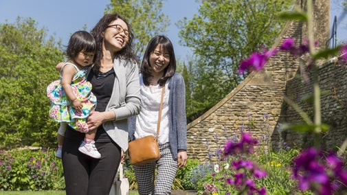 Visitors in the Armillary Court in at Snowshill Manor and Garden, Gloucestershire and Cotswolds